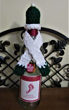 a bottle with a knitted hat and scarf on it