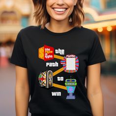 Show your love for the game show in this bold Price is Right Shirt for Super Fan! Designed for those ready to be picked, this Retro Game Show T-Shirt is perfect for live contestants and features a fun "The Path to Win" graphic. Make sure Drew Carey sees you with this eye-catching Come On Down shirt! Please let me know if you have any questions. We love custom order requests!! All designs can be put on sweatshirts, hoodies, tanks, mugs, just send me a message! Additional colors available too! Don Graphic Print Crew Neck T-shirt For Gaming Events, Black Graphic Print Tops For Gaming Events, Graphic Tee T-shirt For Gaming Events, Graphic Print Short Sleeve Tops For Gaming Events, Crew Neck T-shirt With Graphic Print For Gaming Events, Price Is Right Shirts, Drew Carey, Price Is Right, Retro Game