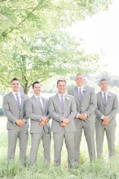 a group of men in suits standing next to each other