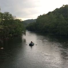 a person in a small boat on a river