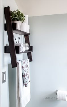 a bathroom shelf with towels and other items on it