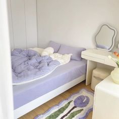 a bedroom with a bed, dresser and mirror on the wall next to a flower vase