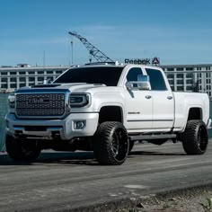 a white truck is parked in front of a building