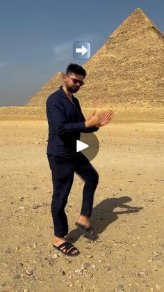 a man standing in front of the pyramids with his hands together and an arrow pointing at him