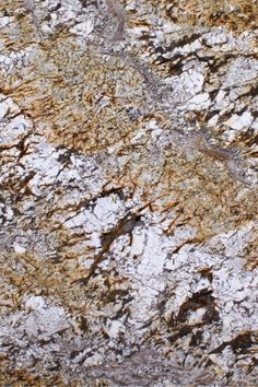 an image of a rock texture that looks like it has been painted gold and white