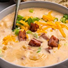 a white bowl filled with cheese and bacon soup