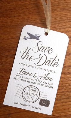 save the date tags are hanging on a wooden table with a brown ribbon and string