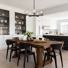 a dining room table surrounded by black chairs