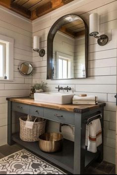 a bathroom with a sink, mirror and rug on the floor in front of it