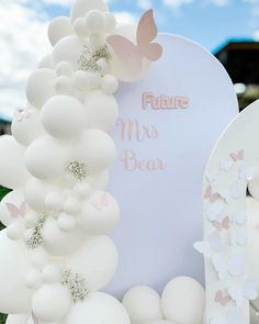 balloons and butterflies decorate the entrance to a wedding ceremony