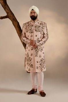 Model showcasing the Frosted Almond Sherwani, exuding timeless charm with its delicate hue.Close-up of the Frosted Almond Sherwani, revealing intricate embroidery and exquisite detailing Pink Sherwani, Jatin Malik, Resham Work, Dhoti Pants, Haldi Ceremony, Royal Look, Indian Man, Indian Wedding Outfits, Pink Linen