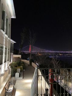 a view of the bay bridge at night from an apartment building in san francisco, california