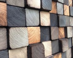 wood is stacked on top of each other to make a wall art piece that looks like it has been cut in half