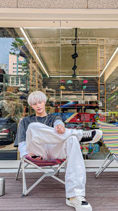 a man sitting in a folding chair with his legs crossed