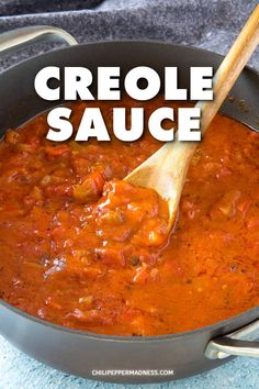 a skillet filled with chili sauce and a wooden spoon in the pan that says, criole sauce