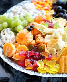 a platter filled with fruit and crackers