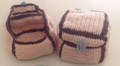 two crocheted baby booties sitting next to each other