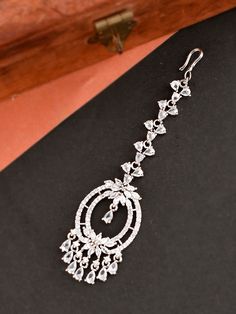 Maang Tikka - White CZ and AD stone silver Indian Tikka / Diamond Maang tikka /Bridal Wear/ Small Tikka /American Diamond Silver Maang Tikka Beautiful and Unique American Diamond (AD) Maang Tikka with floral shape. These would definitely complete your entire look for your special event. This maang tikka has a minimalistic style, are very lightweight, and are perfect for kids as well. Size & Fit Dimensions: 8 cm x 2.8 cm (Length x Width) Care Instructions: Wipe your jewellery with a soft cloth after every use Always store your jewellery in a flat box to avoid accidental scratches Keep sprays and perfumes away from your jewellery Do not soak your jewellery in water Clean your jewellery using a soft brush, dipped in jewellery cleaning solution only Complete The Look Take your ethnic accessori