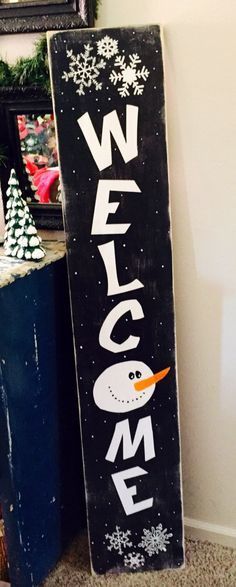 a sign that says welcome with a snowman on it