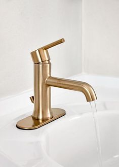 a gold faucet with water running from it