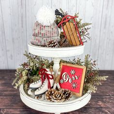 three tiered tray with christmas items on it