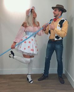 a man and woman dressed in costumes standing next to each other