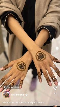 two hands with hendi designs on them