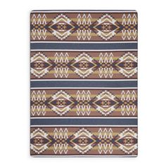 a brown and blue rug with an abstract design on it's side, in front of a white background