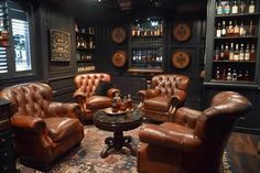 a living room filled with brown leather furniture and lots of bottles on the wall behind it