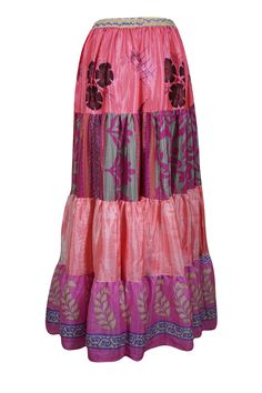 Elevate your wardrobe with the vibrant charm of this flared maxi skirt, skillfully made from upcycled saree fabric. Adorned with rich Rouge Pink and floral patterns alongside bold, eye-catching prints, each silk blends skirt is a unique masterpiece. The adjustable drawstring waist and flowing ankle-length silhouette provide a flattering and comfortable fit, effortlessly combining boho-chic style with everyday practicality. Whether you're wandering through a farmer's market or dancing at a beach Beach Long Skirt, Skirt Patchwork, Flare Maxi Skirt, Boho Skirts, Saree Fabric, Farmer's Market, Silk Skirt, Boho Chic Fashion, Floral Patterns