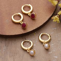 Bathed in radiant 18k gold plating, this set of two hoop dangle earrings captures India's splendor in their classic design presented by Shivani Choudhary. Each pair, in a polished finish, is adorned with ruby jewels or cultured pearls, whose round cut allows for a unique vibe that exudes elegance. Ruby Jewel, Hoop Dangle Earrings, Pearl Dangle Earrings, Jewellery Ideas, Pearl Earrings Dangle, Jewelry Earrings Hoops, Cultured Pearls, Gold Plating, Round Cut