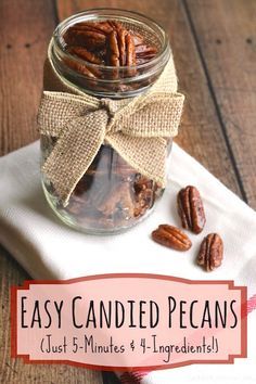 a glass jar filled with pecans sitting on top of a white napkin