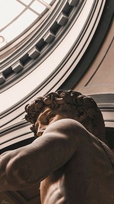 a statue is shown in front of a circular window