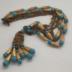 This is a gorgeous multi strand gold coloured necklace. It has turquoise coloured beads that are beautifully attached to the necklace. Unsigned beauty! Very elegant and well made. Definitely a quality piece of jewelry. It has 4 strands. It is in mint condition showing no signs of wear. Measurements are approximately 14" long. Shipping charges are an estimate only. Overages in shipping are promptly refunded. Shipping charges include tracking and insurance. Vintage Multi-strand Turquoise Jewelry, Turquoise Multi-strand Necklace With Dangling Beads, Elegant Gold Turquoise Necklace With Colorful Beads, Vintage Gold Beaded Turquoise Necklace, Necklace Turquoise, Jan 17, Multi Strand Necklace, Turquoise Color, Turquoise Beads