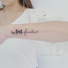 a woman with a tattoo on her arm that says,'family'and three birds