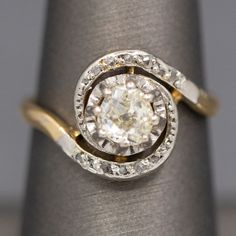 an engagement ring with a diamond in the center on top of a cloth napkin holder