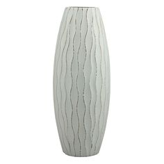 a tall white vase with wavy lines on the bottom and sides, sitting against a white background