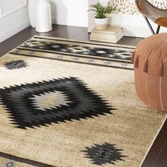 an area rug with black and white designs on it