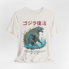 a white t - shirt with an image of a godzilla on it