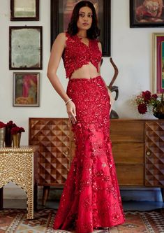 This structured red mermaid lehenga set personifies the emblem of romantic glamour. The set features intricate embroidery of cutdana work and dori with red sequins, beads, and floral applique work adorning both the skirt and blouse. Its focal point is the tassel detailing flowing at the bottom of the skirt with cute flower motifs made of sequins. Sleeveless blouse with floral applique detailing highlighted with nalki crystals and beads. Blouse contains a metal hook on the front side. Heavily embroidered dupatta with botanical motifs detailing accentuated with sparkling sequins and crystals. Lehenga skirt adorned with floral applique handwork detailing and drop-down tassels adorning the bottom of the skirt. Lehenga contains a left zipper for support along with a metal hook. Mermaid Lengha, Mermaid Lehenga, Red Sequin Lehenga, Bride Reception Dresses, Red Mermaid, Lehenga Blouse Designs, Long Dress Design, Lehenga Skirt, Desi Clothes