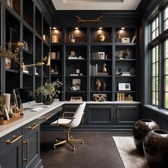 an elegant home office with black cabinets and gold accents