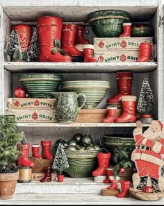 a shelf filled with lots of christmas themed dishes and decorating utensils on top of each other