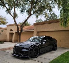 a black car parked in front of a house