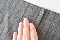 a person's hand on the edge of a piece of fabric