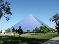 a large white pyramid sitting in the middle of a park