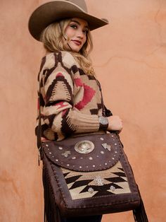 On our last trip to Santa Fe I found the most amazing bags. We hit it off and away we went. I met with her at her studio on our way out of town and went over our favorite designs. Native made and inspired, using 1920's vintage rugs, deer skin and vintage sterling silver, our South by Southwest bags are the finest Navajo rug bags on the market. These will start rolling in soon, each bag one of a kind! This large messenger style bag boast 30 sterling conchos, Two sterling arrows, a beautiful stamp Bohemian Satchel Saddle Bag For Travel, Artisan Brown Bag For Fall, Brown Bohemian Saddle Bag For Travel, Bohemian Brown Saddle Bag For Travel, Bohemian Hand-tooled Saddle Bag For Travel, Southwestern Brown Rectangular Shoulder Bag, Southwestern Style Brown Rectangular Shoulder Bag, Brown Southwestern Rectangular Shoulder Bag, Bohemian Hand Tooled Satchel For Travel