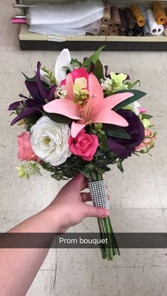 a person holding a bouquet of flowers in their hand