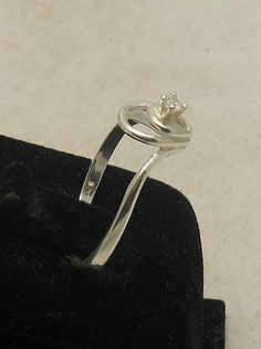 Sterling silver ring with 2.5mm round CZ - R000831. Stamped 925. Approximate weight 1.6 grams. Top width 1.0 cm (0.40 inches), band width 1.5mm (0.006 inches). All our jewels are made from solid sterling silver 925/1000 and are carefully crafted by hand in our family workshop. We dispatch your orders in 5 working days, worldwide and the postage is $5. We ship registered priority mail. Please allow 5-7 working days for delivery in Europe and 10-15 working days outside Europe. For any questions - Adjustable Silver Ring With Single Diamond, Silver Stackable Rings With Tension Setting, Adjustable Silver Ring With Tension Setting, Classic Silver Birthstone Ring With Tension Setting, Classic Silver Birthstone Ring With Single Diamond, Silver Classic Birthstone Ring With Single Diamond, Silver Birthstone Ring With Single Diamond, Silver Sterling Birthstone Ring With Diamond, Silver Engagement Ring