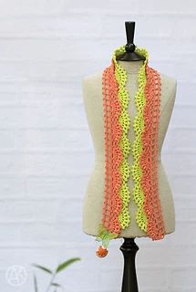 an orange and yellow scarf on top of a mannequin