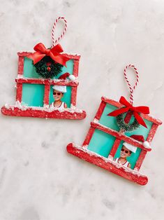 two christmas ornaments made to look like frames